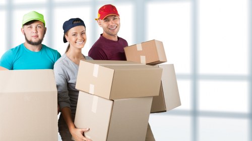 Packed office equipment and labelled boxes ready for relocation