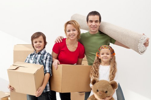 Unpacking boxes into a new flat, showing organised moving day support in Lambeth