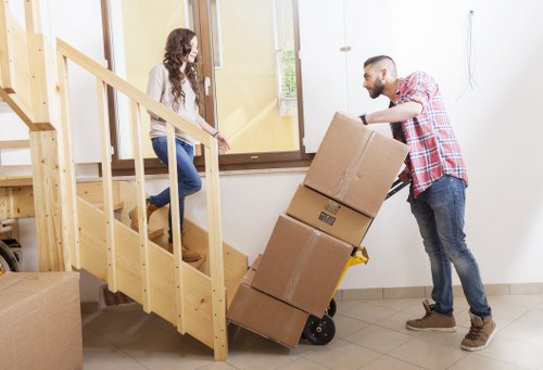 Professional movers carrying furniture in a Lambeth property
