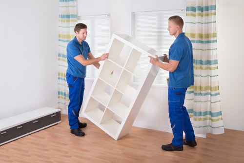 Professional movers handling office furniture in a Lambeth workspace