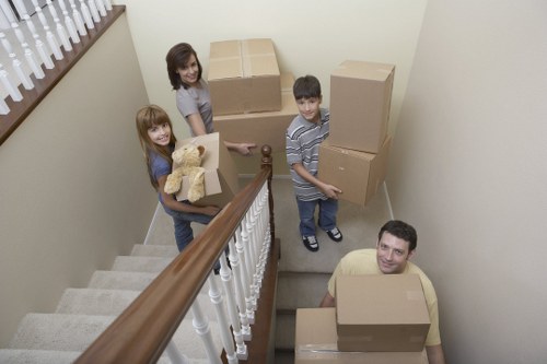 Worker assessing and lifting a box with proper manual handling technique